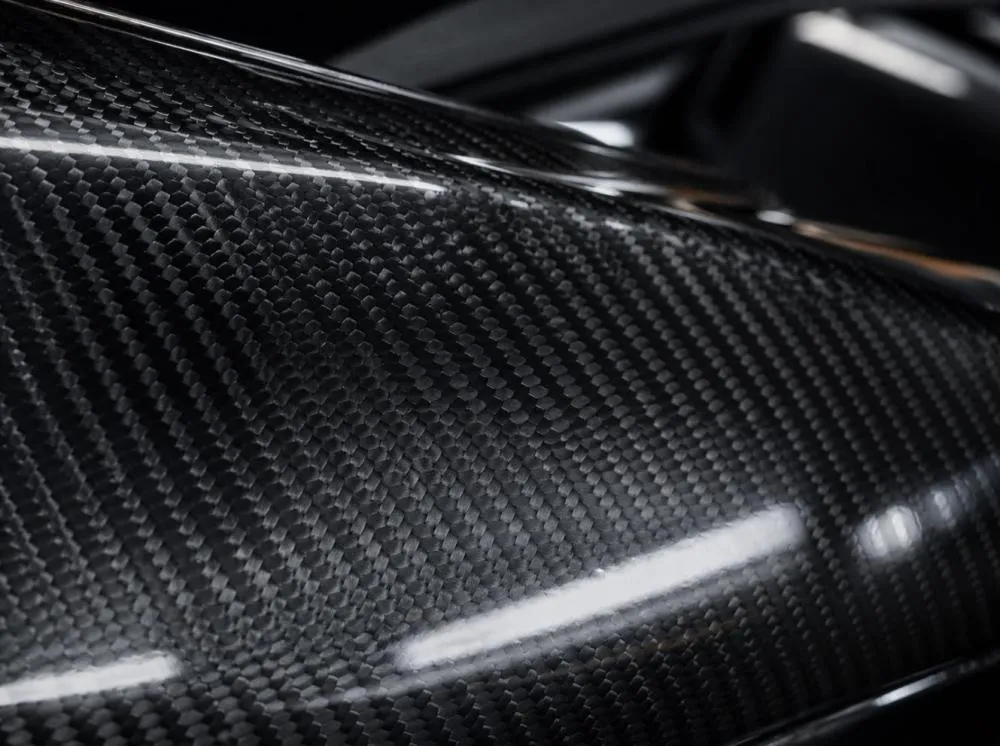 Close-up detail of carbon fiber weave used on luxury car parts