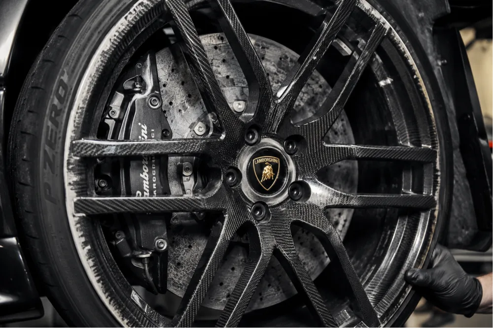 Detailed view of a used Lamborghini carbon fiber wheel and performan