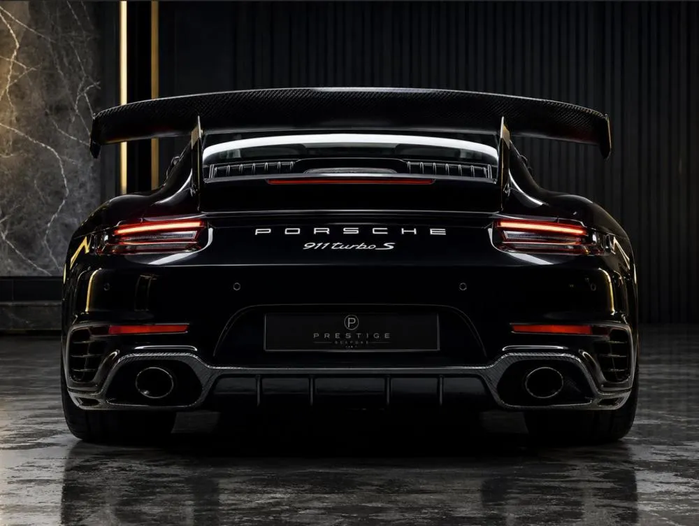 Luxury sports car rear view with carbon fiber style spoiler
