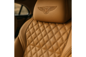 Close-up of tan leather Bentley seat with diamond stitching